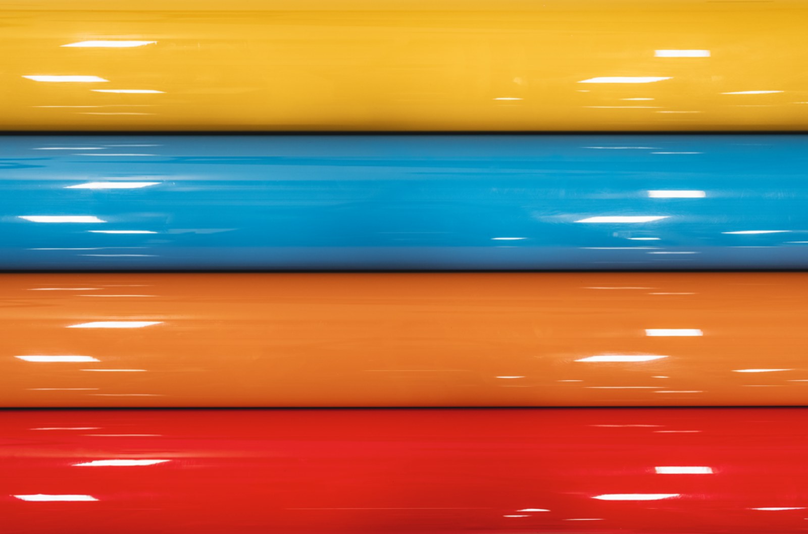 Rolls of vinyl wrap film in yellow, blue, orange, and red